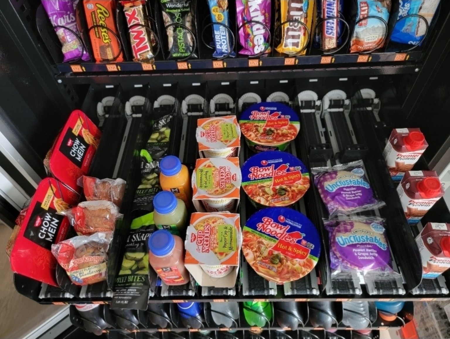 Vending conveyor rows stocked with noodles, sandwiches and grab-and-go food