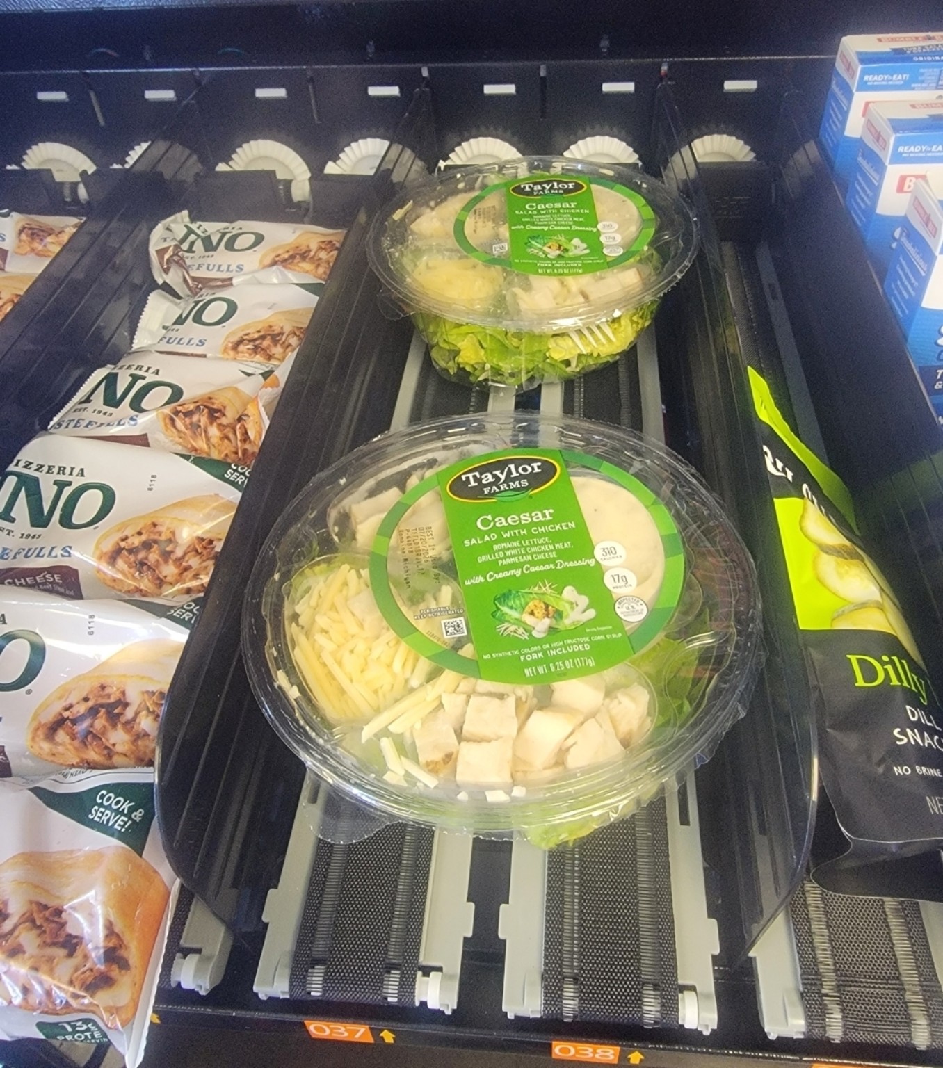Vending conveyor rows holding salads and prepared food